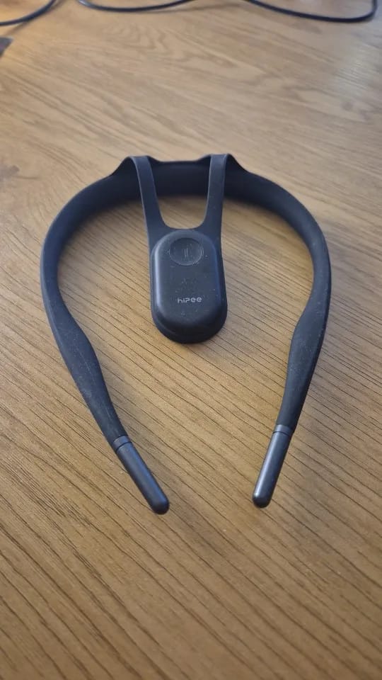 Uprexa posture trainer resting on a wooden desk